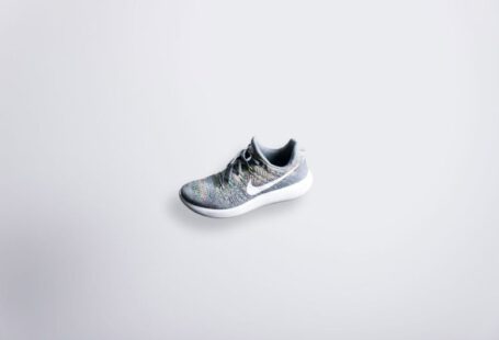 Comfortable Shoe - unpaired gray and white Nike Flyknit shoe