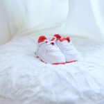 Children Shoes - white and red nike sneakers on white textile