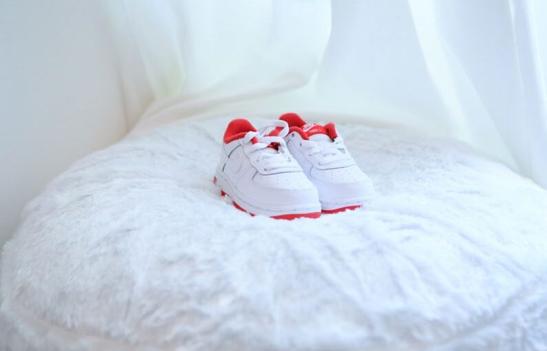 Children Shoes - white and red nike sneakers on white textile