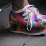 Platform Shoes - person wearing multicolored wedge shoes