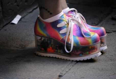 Platform Shoes - person wearing multicolored wedge shoes