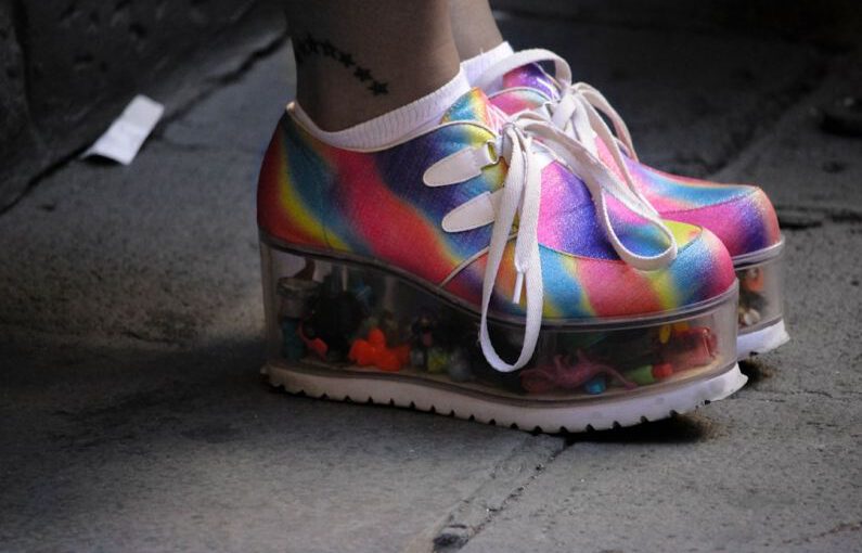 Platform Shoes - person wearing multicolored wedge shoes