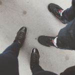 Metallic Shoes - person in blue denim jeans and black and white sneakers