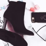 Heels Trend - pair of black booties and iPhone 8 Plus