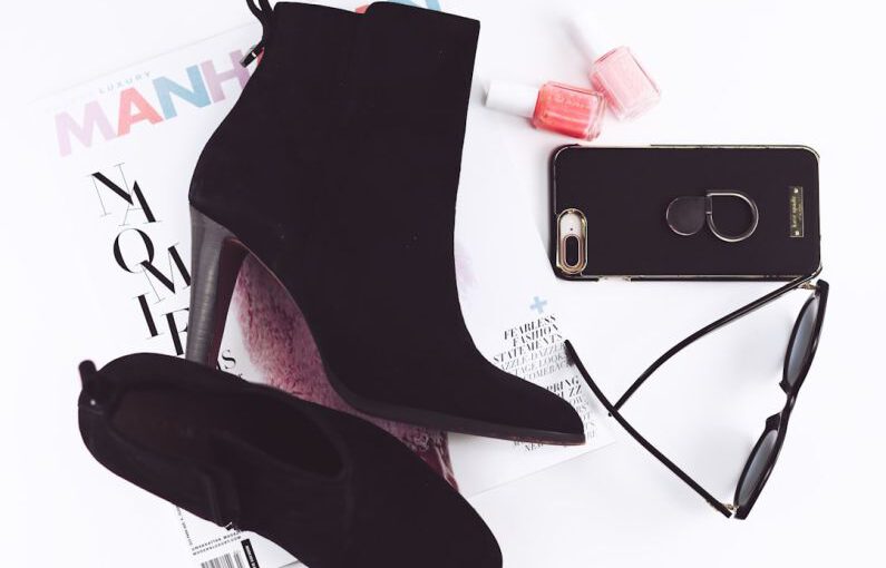 Heels Trend - pair of black booties and iPhone 8 Plus