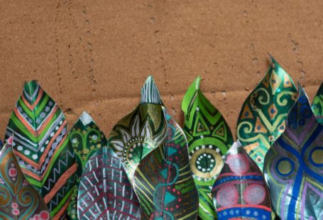 Biodegradable Shoes - a group of colorful paper flowers sitting on top of a table