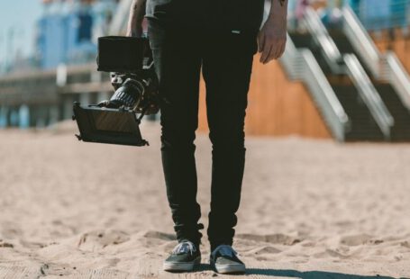 Shoe Production - person holding shoulder-mount camcorder