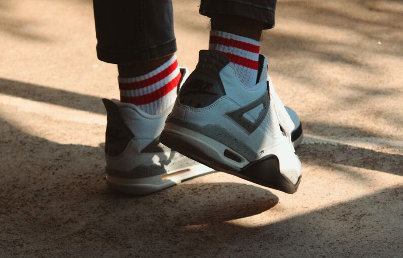 Retro Sneakers - a person wearing white and black shoes