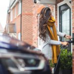 Carbon Footprint Shoes - a woman is opening the door of her house