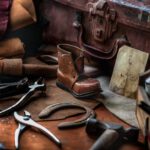 Shoe Repair - assorted hand tools with unpaired brown work boot