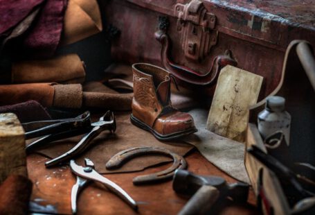 Shoe Repair - assorted hand tools with unpaired brown work boot