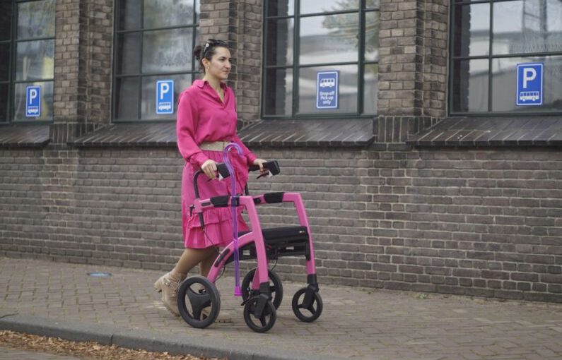 Transform Shoes - a woman in a pink dress pushing a pink walker