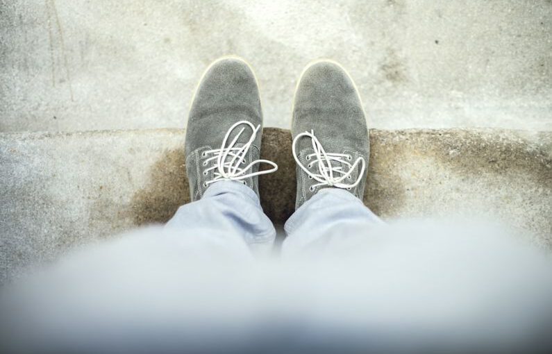 Clear Shoes - person taking a picture of gray shoes
