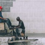 Shoe Polishing - man sitting on stool cleaning shoes at the alley