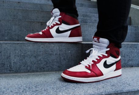 Adding Bling Shoes - person wearing pair of red-and-white Air Jordan 1 shoes