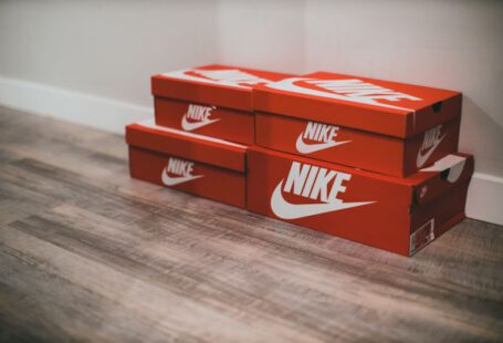 Personalized Sneakers - a pair of red nike boxes sitting on top of a wooden floor