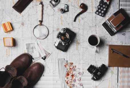 Shoes Vintage Transformation - camera, pair of brown shoes, white ceramic mug, grey and black pen, brown smoking pipe