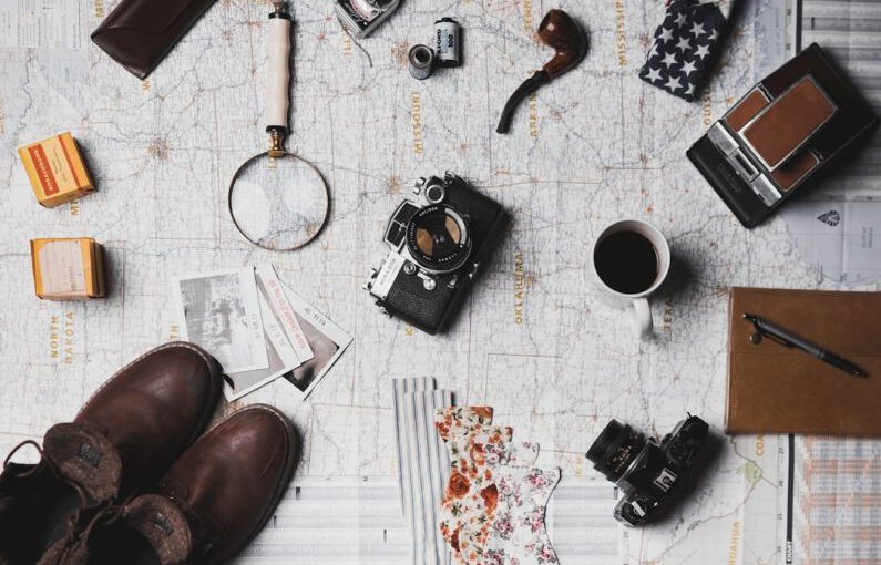 Shoes Vintage Transformation - camera, pair of brown shoes, white ceramic mug, grey and black pen, brown smoking pipe