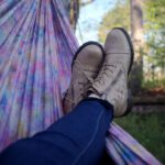 Shoe Dyeing - person lying on pink and purple hammock surrounded with trees