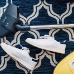 Eco Shoes - pair of white sneakers beside vacuum cleaner