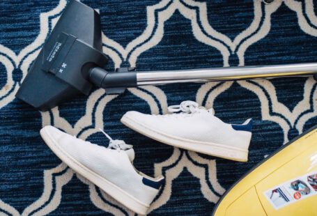 Eco Shoes - pair of white sneakers beside vacuum cleaner