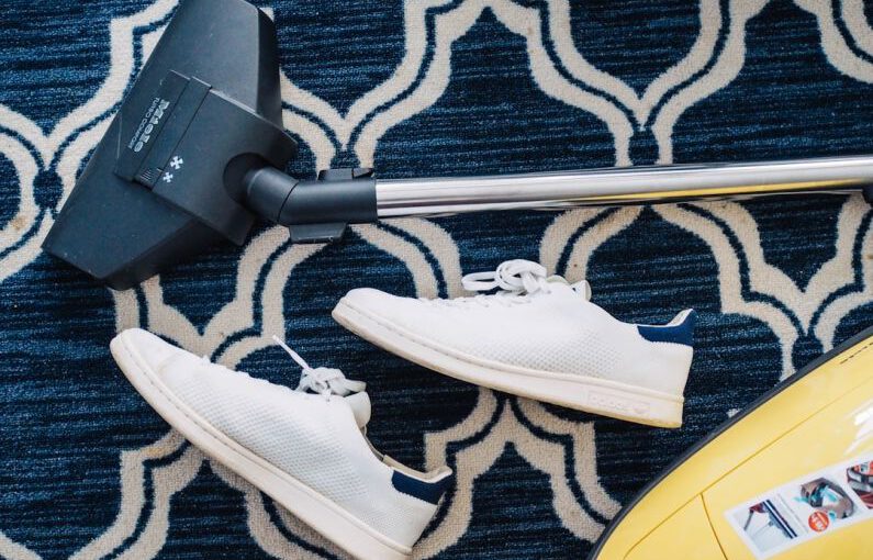 Eco Shoes - pair of white sneakers beside vacuum cleaner