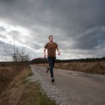 Personalizing Running Shoes - man running at the road during daytime