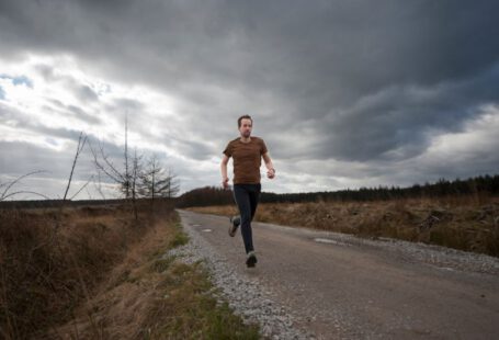 Personalizing Running Shoes - man running at the road during daytime