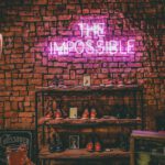 Classic Shoes - The Impossible neon light signage on brick wall