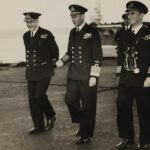 Royal Footwear - grayscale photo of three men walking on concrete pavement