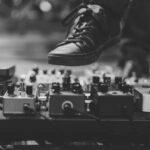 Shoe Production - person wearing black lace-up sneaker hitting the distortion