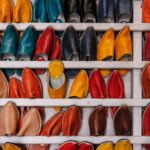 Shoe Craftsmanship - assorted-color shoe lot on white wooden shelf