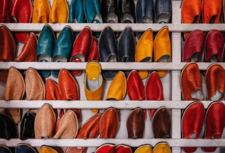 Shoe Craftsmanship - assorted-color shoe lot on white wooden shelf
