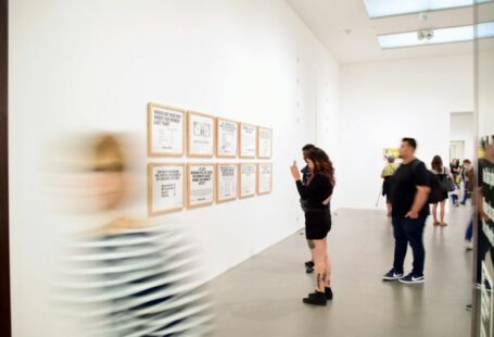 Footwear Exhibits - three men and woman standing while looking at bulletin board