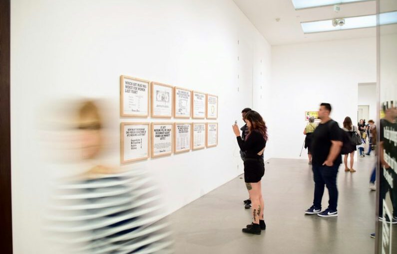 Footwear Exhibits - three men and woman standing while looking at bulletin board