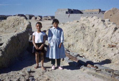 Archaeological Footwear - 2 women standing on gray sand during daytime