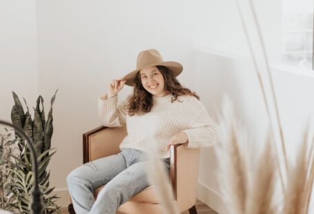 Shoe Sizes - woman in white long sleeve shirt and gray pants sitting on brown wooden seat