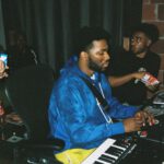 Expensive Shoes - man in blue button up shirt playing piano